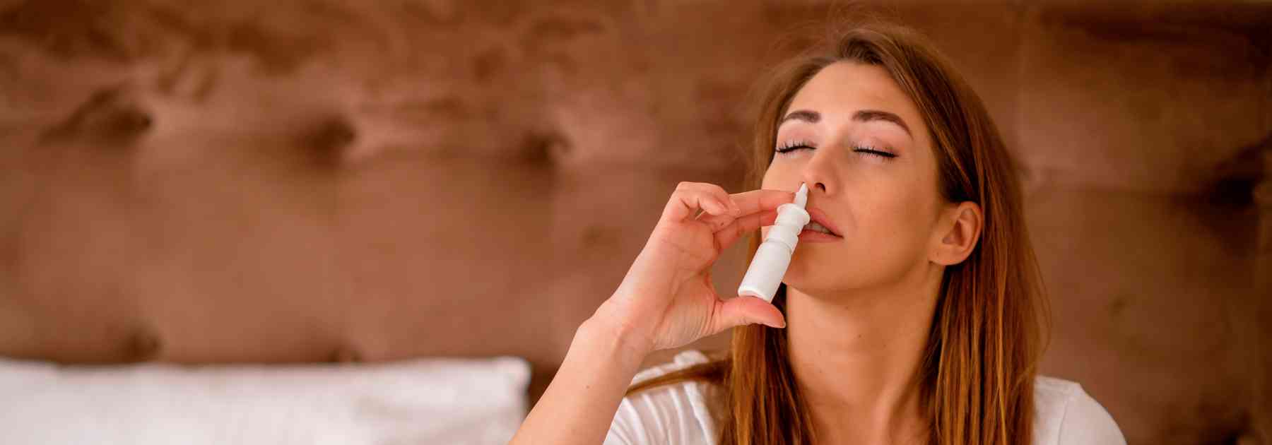 woman using nasal spray