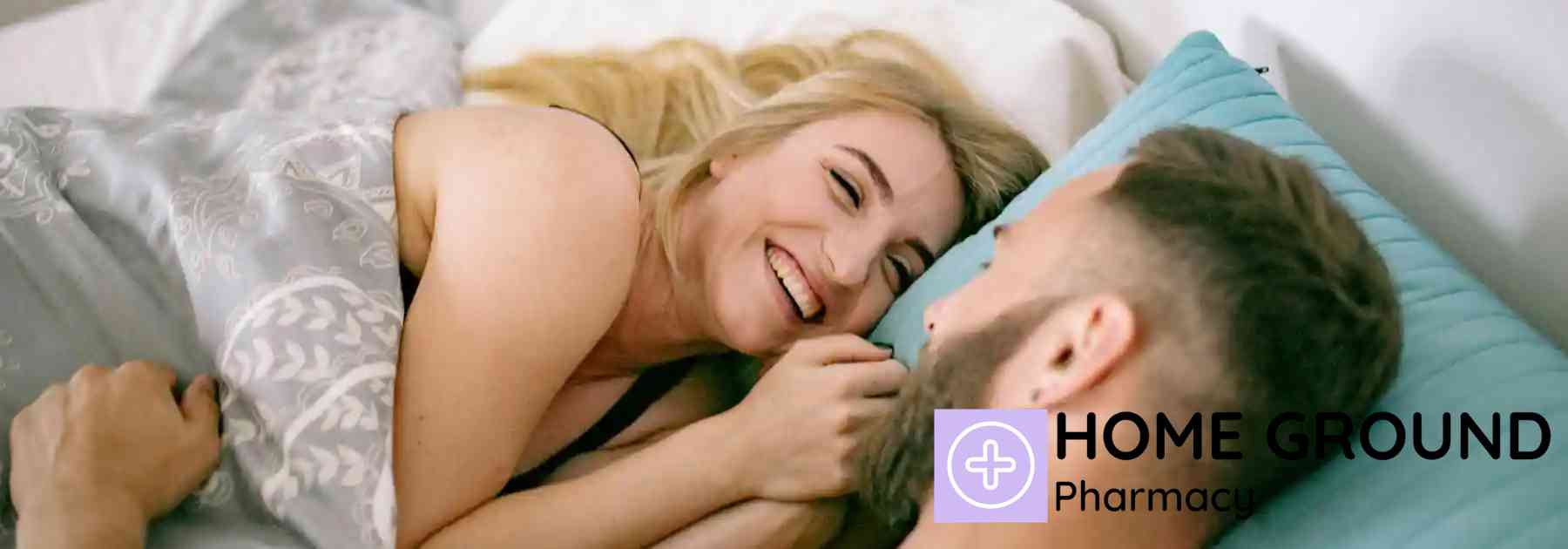 smiling couple lying in bed