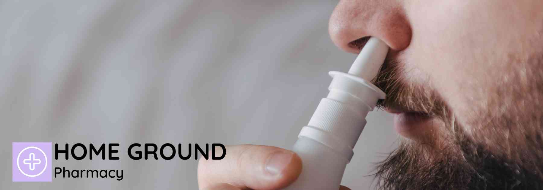 close-up of man using nasal spray