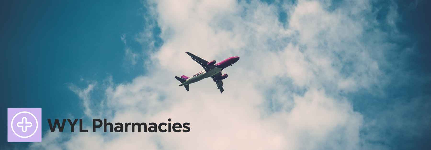 plane flying in blue cloudy sky
