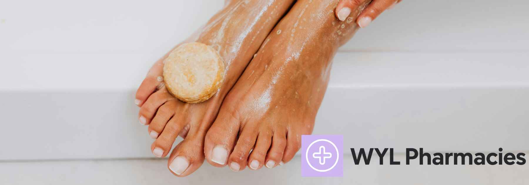 person washing their feet with soap and water