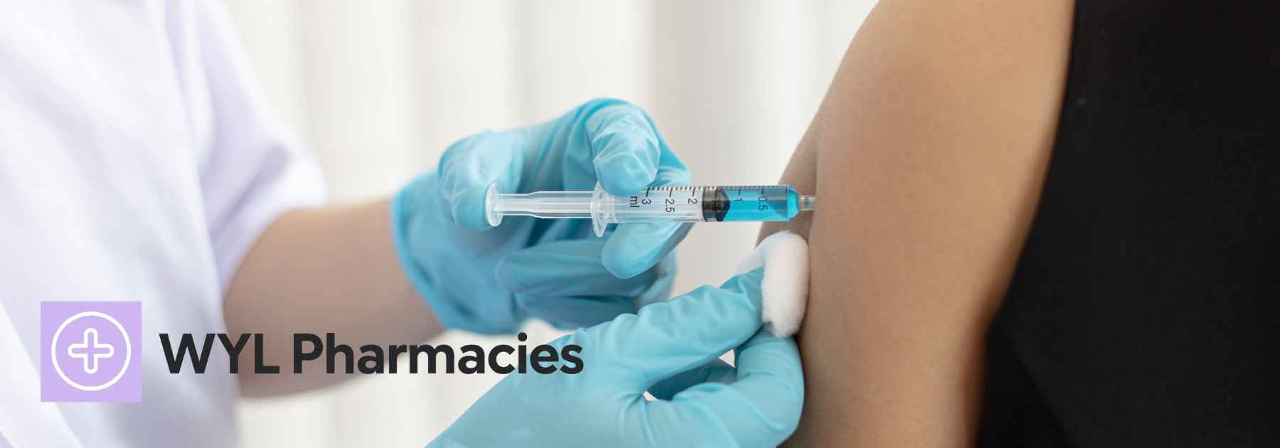 patient wearing black shirt receiving vaccine