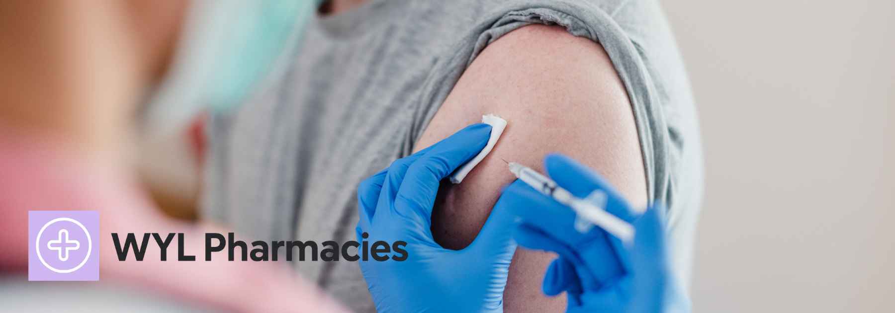 male patient in grey shirt receiving vaccine