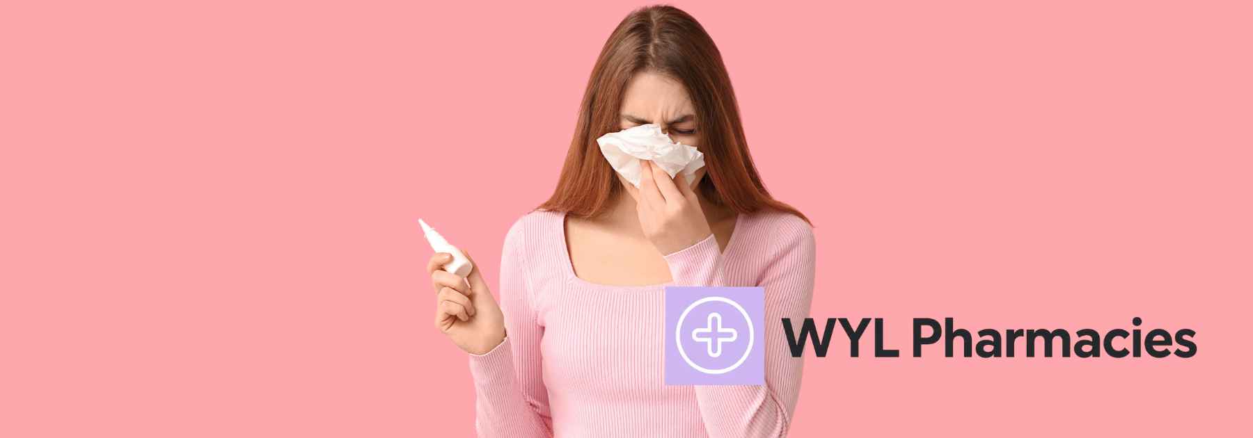 young woman blowing her nose and holding nasal spray on pink background