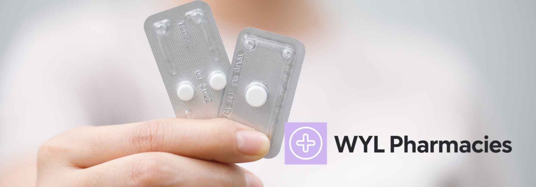 woman holding three contraceptive pills
