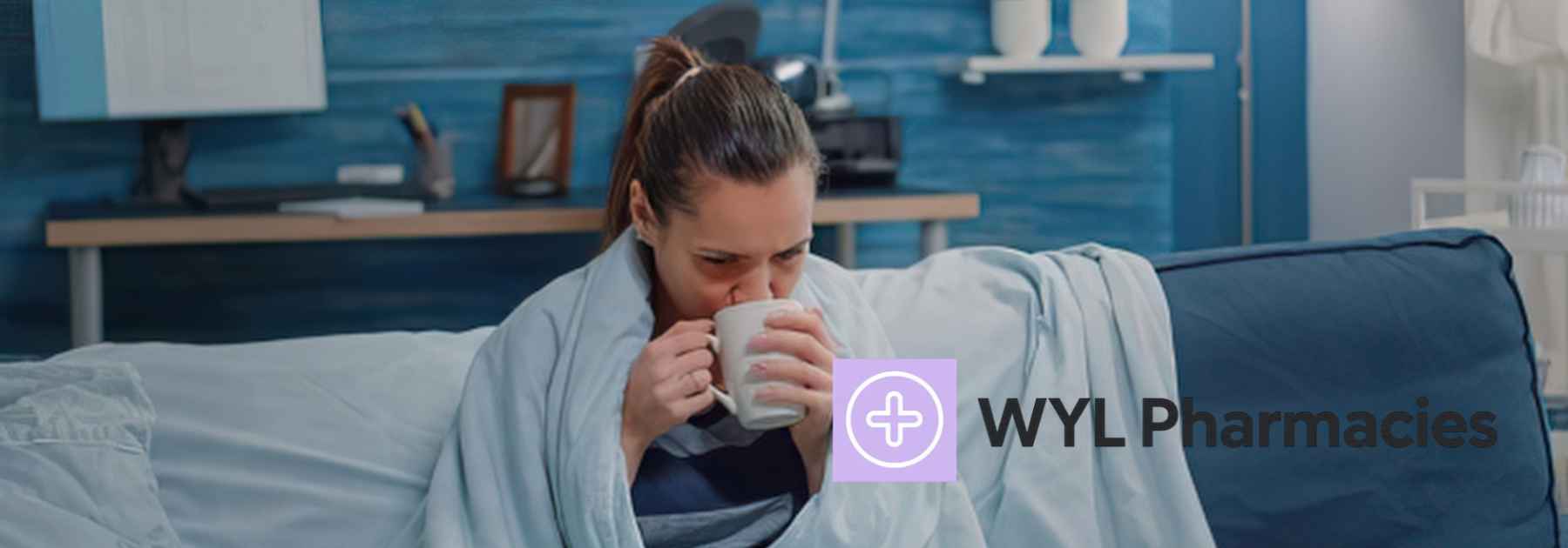 woman sitting on couch sipping hot drink from mug